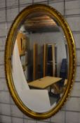 Oval gilt framed wall mirror