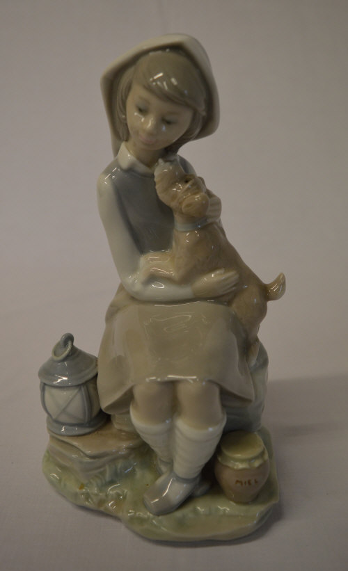 Lladro figure of a girl sat with a dog