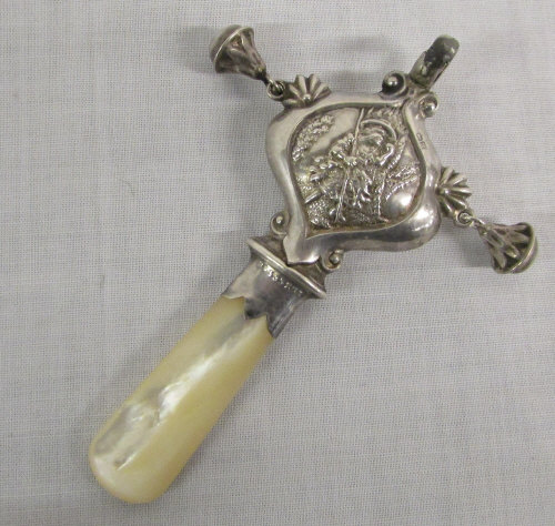 Child's silver rattle with mother of pea
