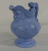 Staffordshire blue glazed mask jug H 20