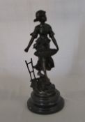 Bronze figure of a lady with basket H 33