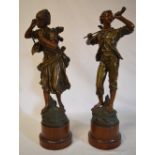 A pair of spelter figures raised on circ