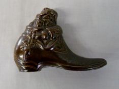 Small brown boot paperweight containing