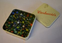 Tin of mixed size marbles