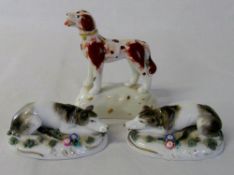 Pair of small porcelain lying dogs & a s