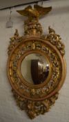 Ornate gilt wall mirror with eagle finia