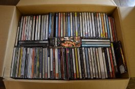 Box of various music CDs