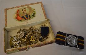Box of various military badges, cap badg