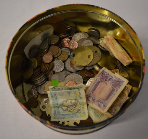 Tin of old coins and bank notes