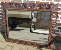 Large ornately carved oak framed mirror