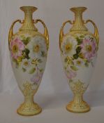 A pair of hand painted vases in the Roya
