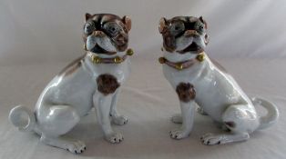 Pair of Dresden seated pug dogs, blue ma