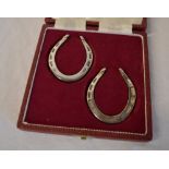 Cased pair of miniature silver horseshoe