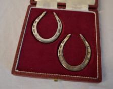 Cased pair of miniature silver horseshoe