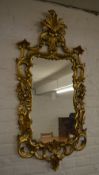 Ornate gilt wall mirror in the rococo st