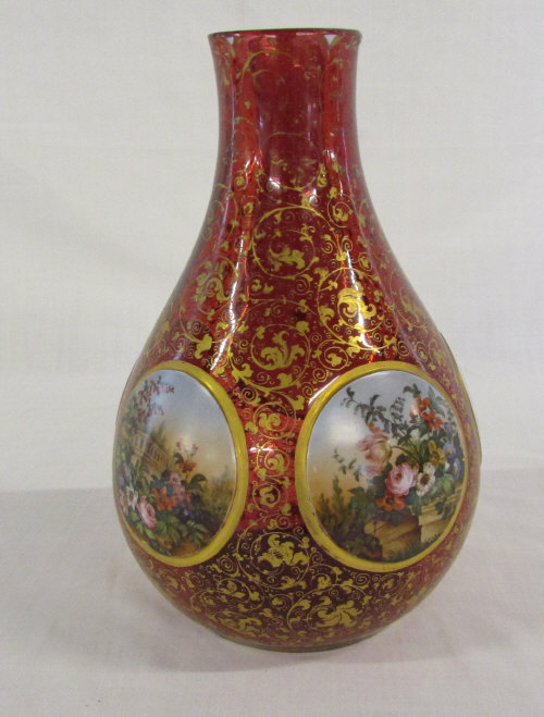 Ruby glass vase with floral decorations