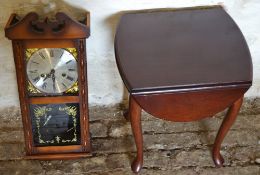 Small mahogany table and a wall clock