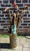 Walking sticks/umbrella in a brass stand