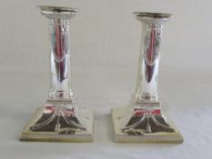 Pair of weighted silver candlesticks wit