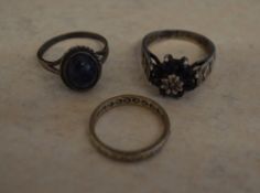 2 silver rings and one yellow metal ring