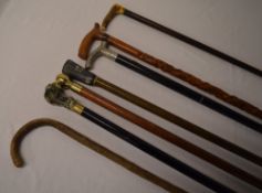 Various walking sticks including one wit