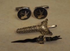 Pair of cufflinks and a tie pin in the f