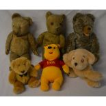 Various old teddy bears and a modern Win