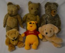 Various old teddy bears and a modern Win
