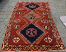 Red ground Persian Qashqai tribal rug wi