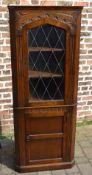 Carved oak corner cabinet with leaded gl