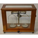 Balance scales in a wooden / glass case