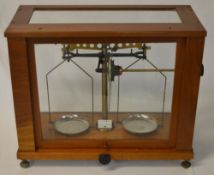 Balance scales in a wooden / glass case