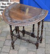 Heavily carved oak oval gate leg table