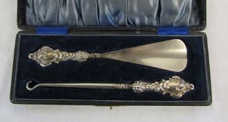 Cased silver handled shoe horn and butto