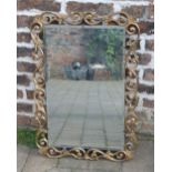 Ornate gilt framed wall mirror with beve