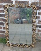 Ornate gilt framed wall mirror with beve