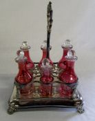 Cranberry glass cruet set in a silver pl