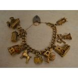 A 9ct gold charm bracelet with 9 differe