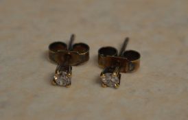 Pair of small 9ct gold diamond earrings,
