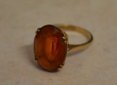 9ct gold ring with an orange coloured st