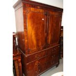 A 19th Century mahogany linen press, the upper section fitted shelves enclosed two panelled doors,