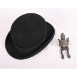 A bowler hat by Bennetts London, size 6 7/8, and a brass fox's head door knocker