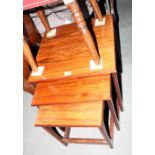 A nest of three 1960s teak occasional tables, on shaped supports