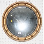 A Regency design convex wall mirror in ball decorated gilt frame and a Rococo design firescreen