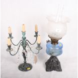 A Victorian oil lamp with moulded glass shade, blue glass reservoir and cast metal base, another