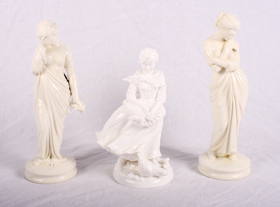 A pair of Worcester blanc de chine figures of a lady with a bird, 9 1/2" high, and another figure of