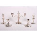 A silver three-branch candelabrum, a pair of matching candlesticks and a pair of filled silver