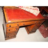 A late 19th Century twin pedestal desk with red tooled inlet leather top, fitted nine drawers, 42"