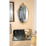 An Art Deco frameless wall mirror and an oval gilt framed wall mirror