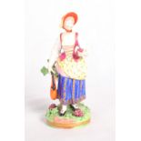 A Stevenson & Hancock Derby porcelain figure of a lady holding a bunch of grapes and a bottle, 6 1/